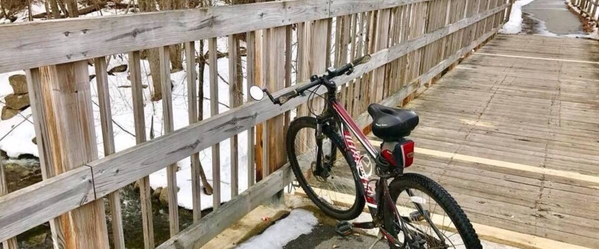 A wooden bridge with a bicycle parked on it.