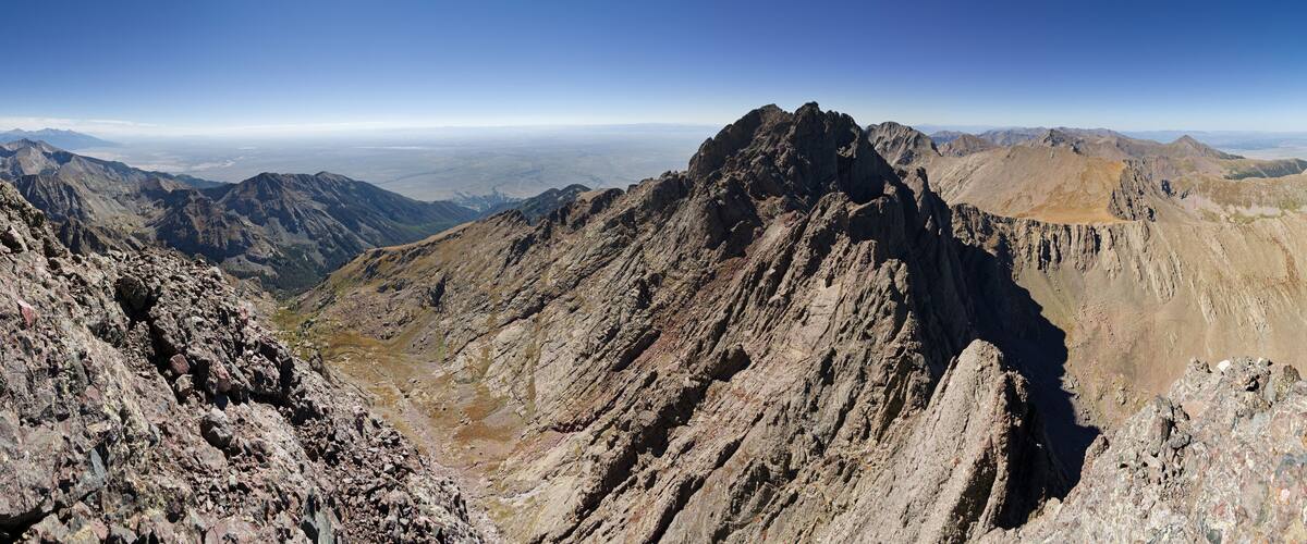 A rugged mountain range with sharp peaks and rocky terrain.