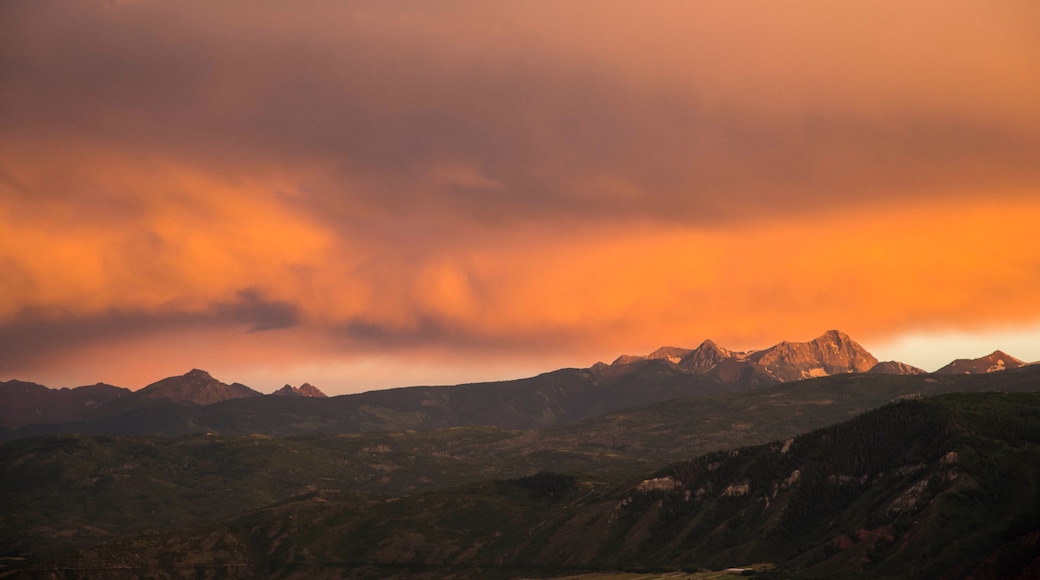 Mountain scene with dramatic cloudy sunset