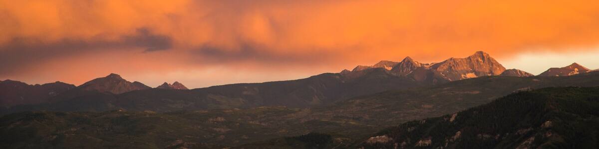 Mountain scene with dramatic cloudy sunset