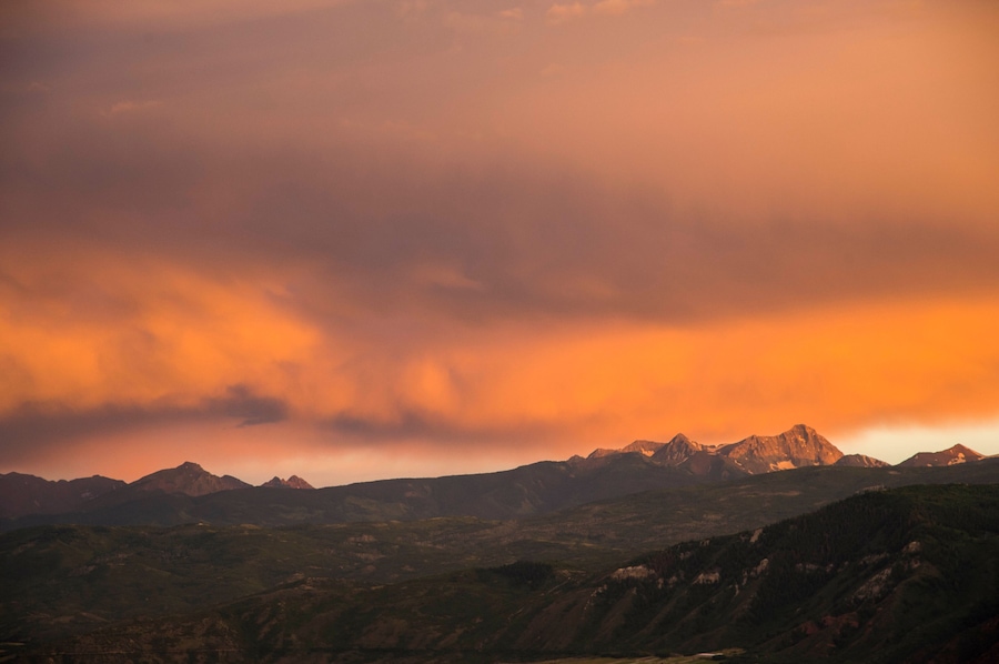 Mountain scene with dramatic cloudy sunset