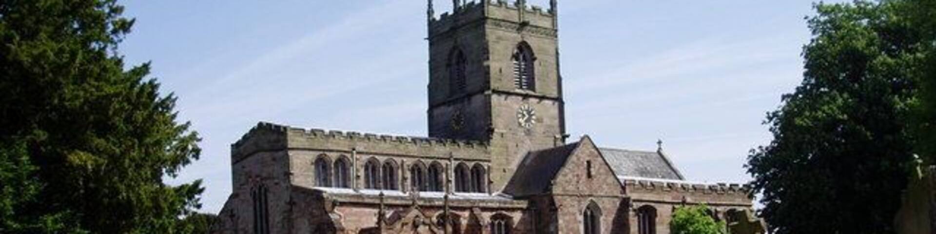 A church with a tall tower and arched windows.