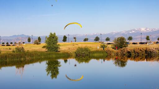 Paraglider flying over lake