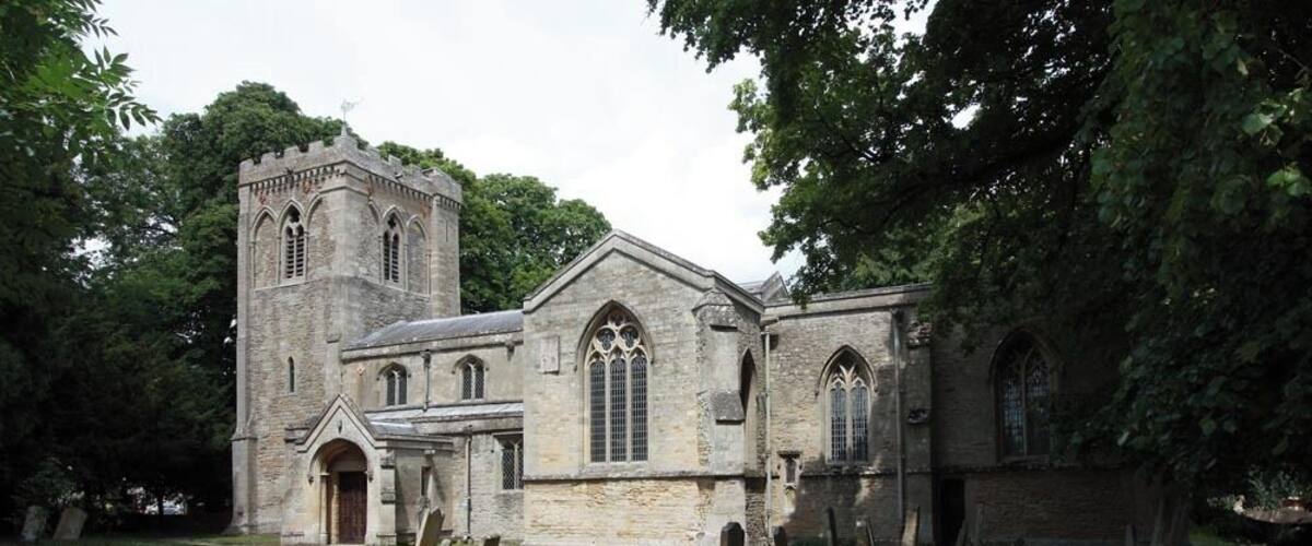 A historic church with a tall tower and arched windows.
