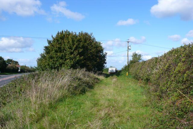 Old Road, New Road When the Dorchester to Yeovil road straightened many years ago, several small parts of the old road were left isolated. Their only use now is as quiet parking places, as in this case, for a milk delivery man taking his lunch break. The new A37 can be seen on the left.