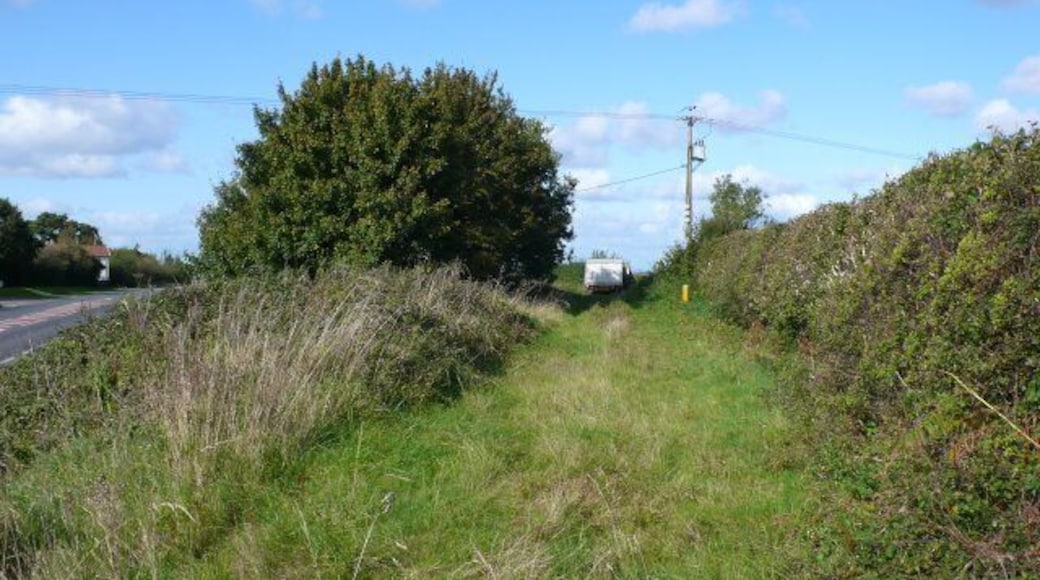 Old Road, New Road When the Dorchester to Yeovil road straightened many years ago, several small parts of the old road were left isolated. Their only use now is as quiet parking places, as in this case, for a milk delivery man taking his lunch break. The new A37 can be seen on the left.
