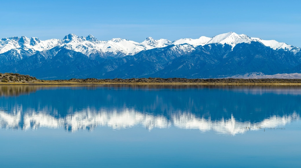 Sangre de Cristo Mountains - Panoramic view of Snow-capped Sangre de Cristo Mountains, reflecting in San Luis Lake. Colorado, USA.