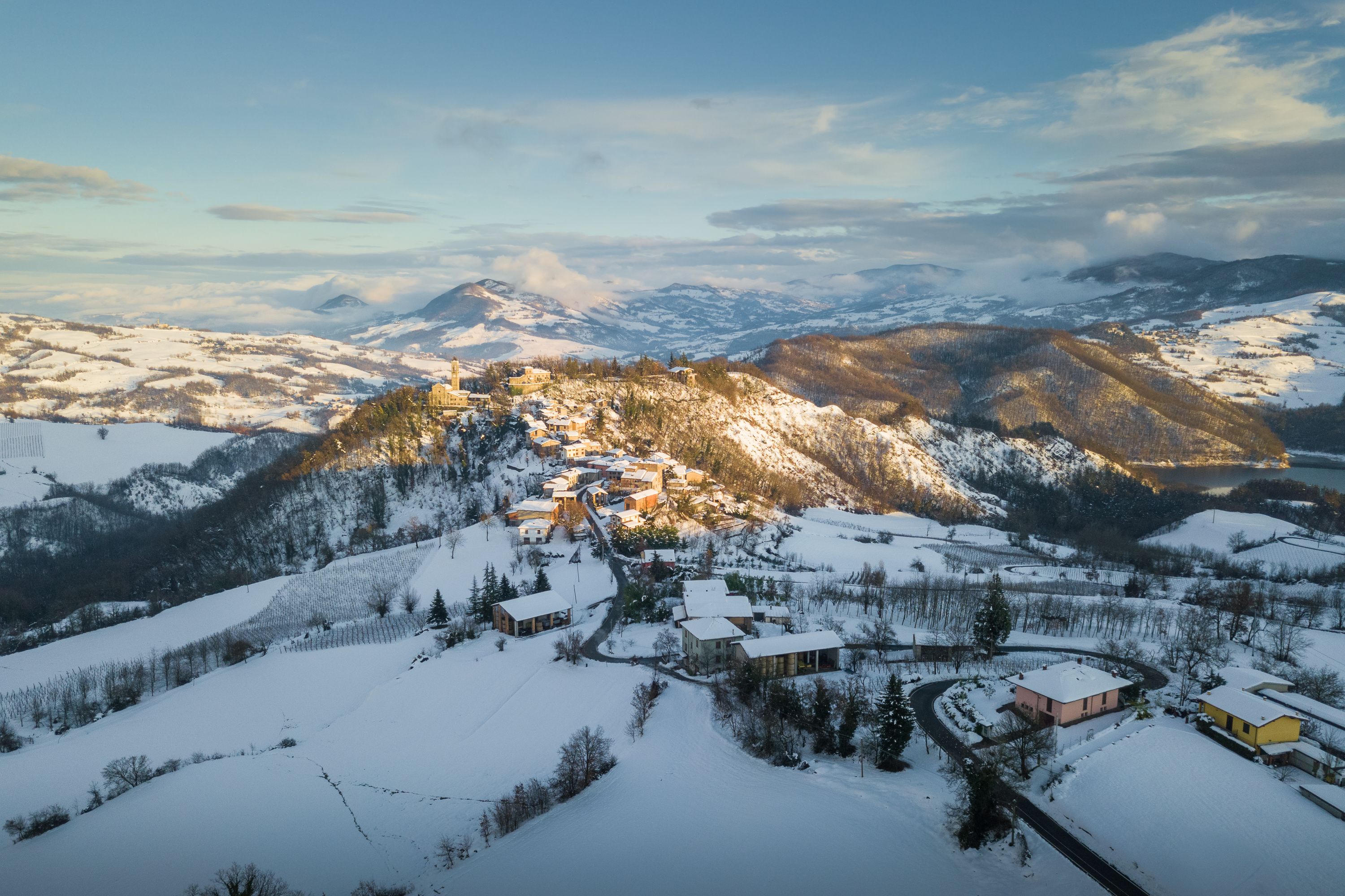 Un village de montagne enneigé, avec des bâtiments et une église.