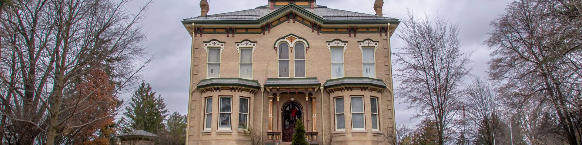 A large, historic building with a prominent tower and arched windows.