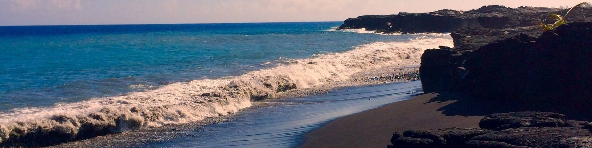 Black sand beach in Kiamu Beach Park in Hawaii.