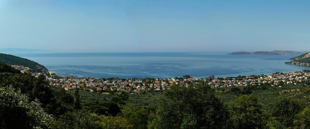 A coastal town with a view of the sea and hills.