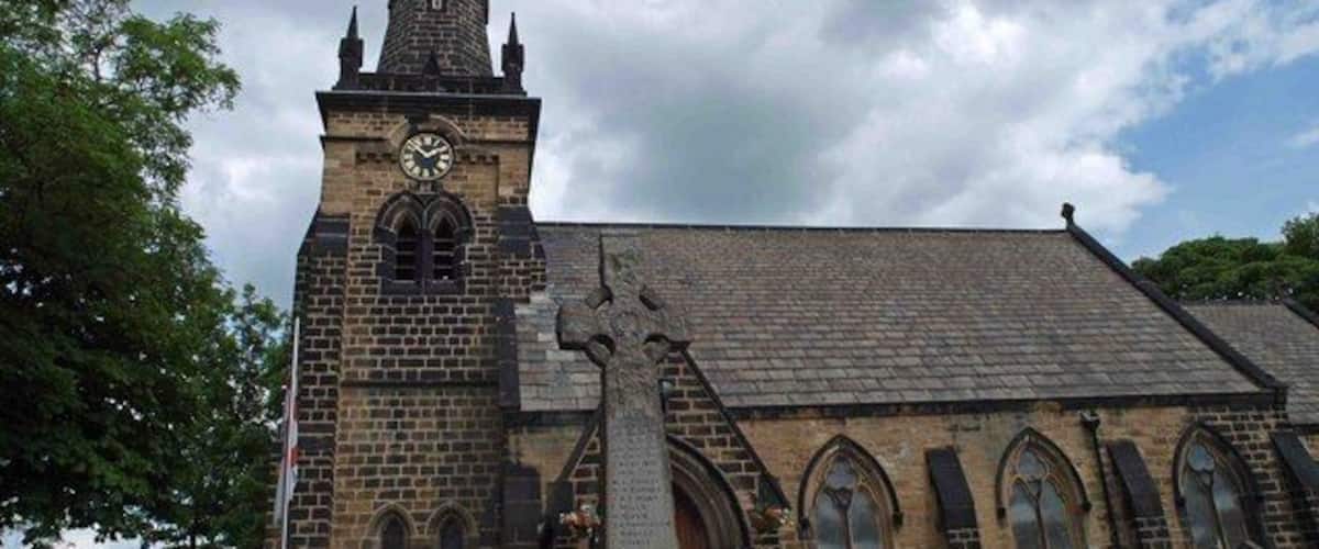 A historic church with a tall steeple and a clock.