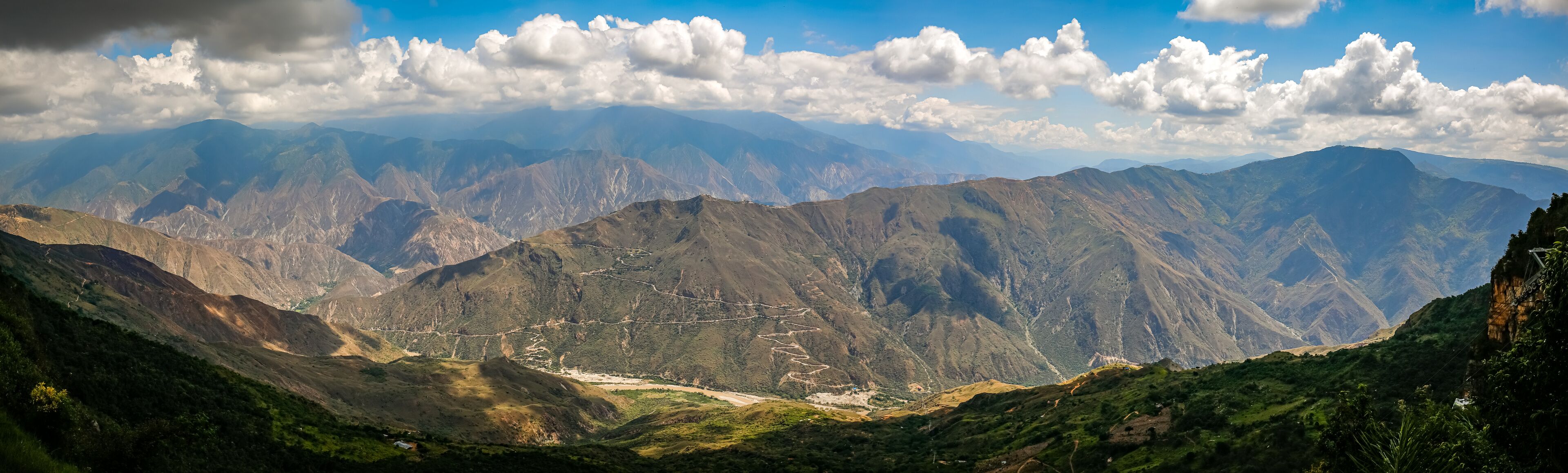 Impressive view to mountains  and Chicamocha canyon with white clouds from Monument of the Virgin Mary at Chicamocha National Park, Colombia