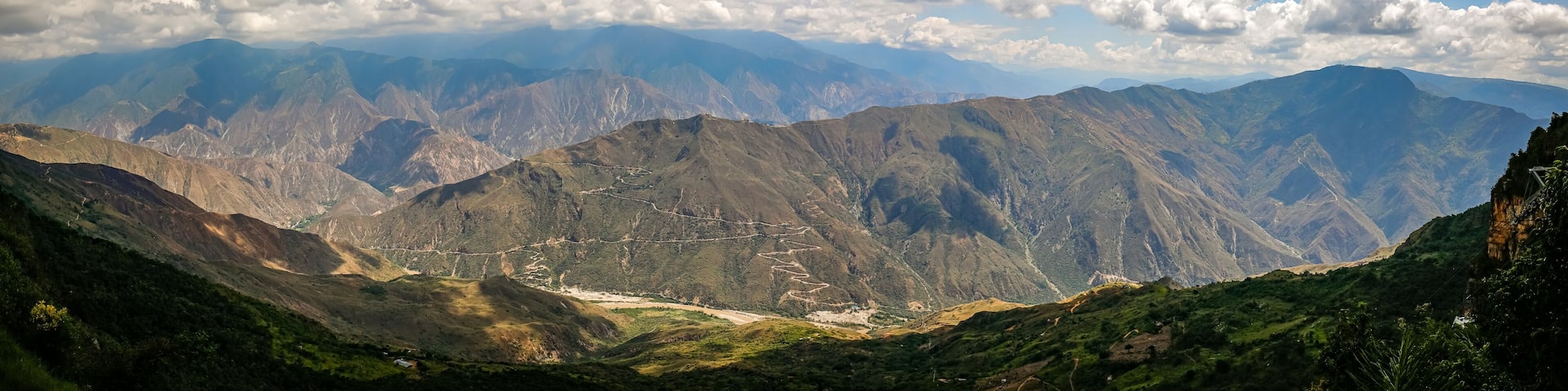 Impressive view to mountains and Chicamocha canyon with white clouds from Monument of the Virgin Mary at Chicamocha National Park, Colombia