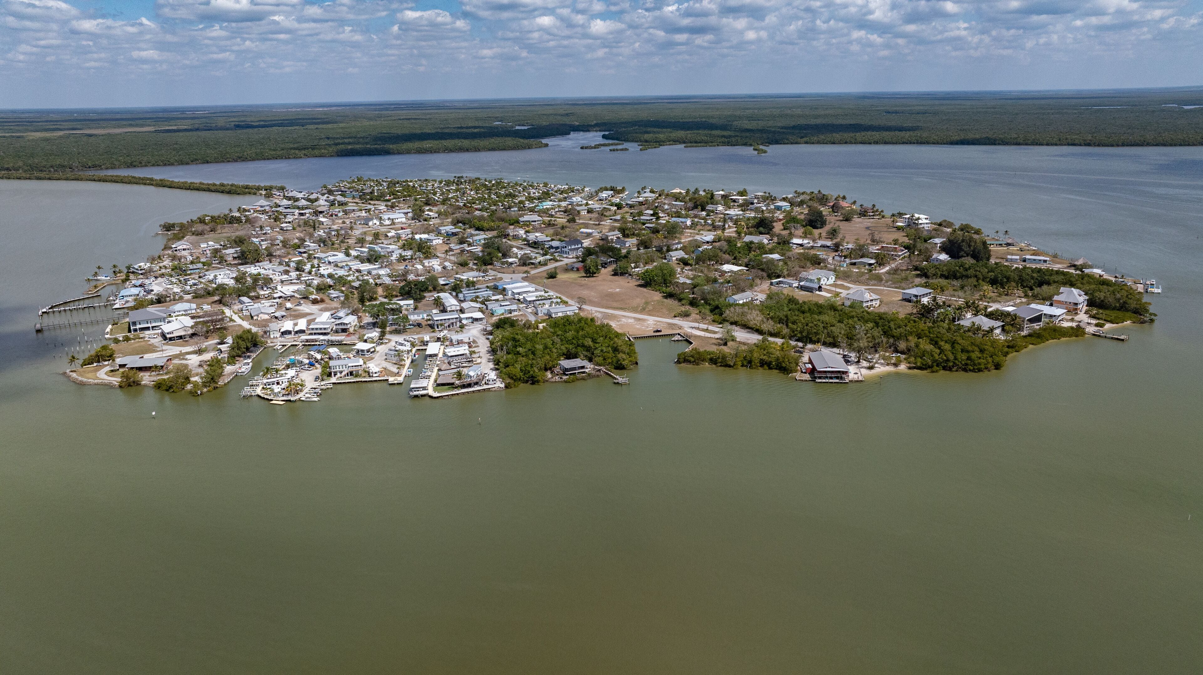 aerial view of Chokoloskee Island from southwest, located at the edge of the Ten Thousand Islands and Everglades in Collier County, Florida,  connected to Everglades City on the mainland by a causeway
