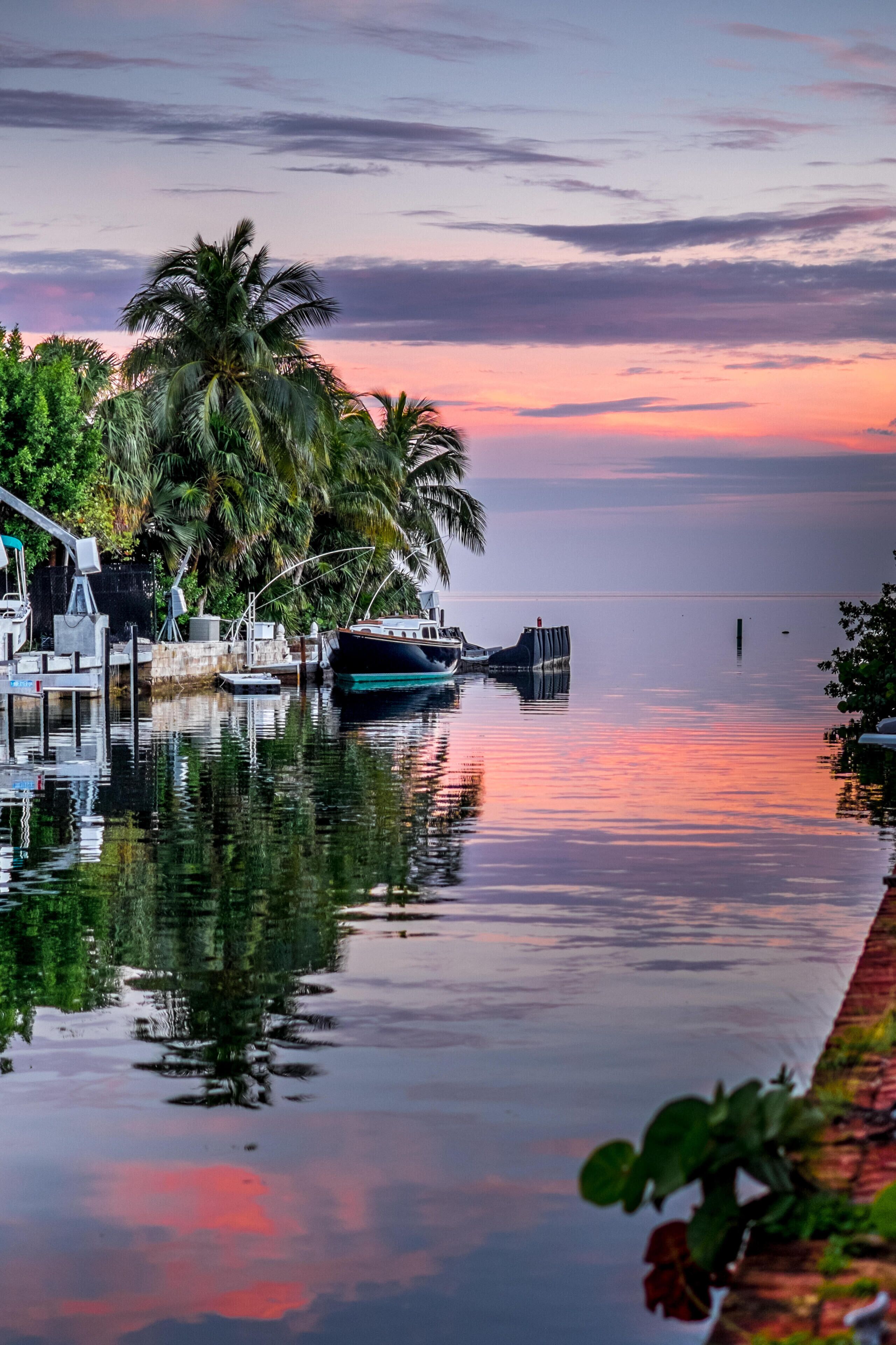 H8X881 Cudjoe Key Florida during a sunset canal boats orange sky red blue mangroves