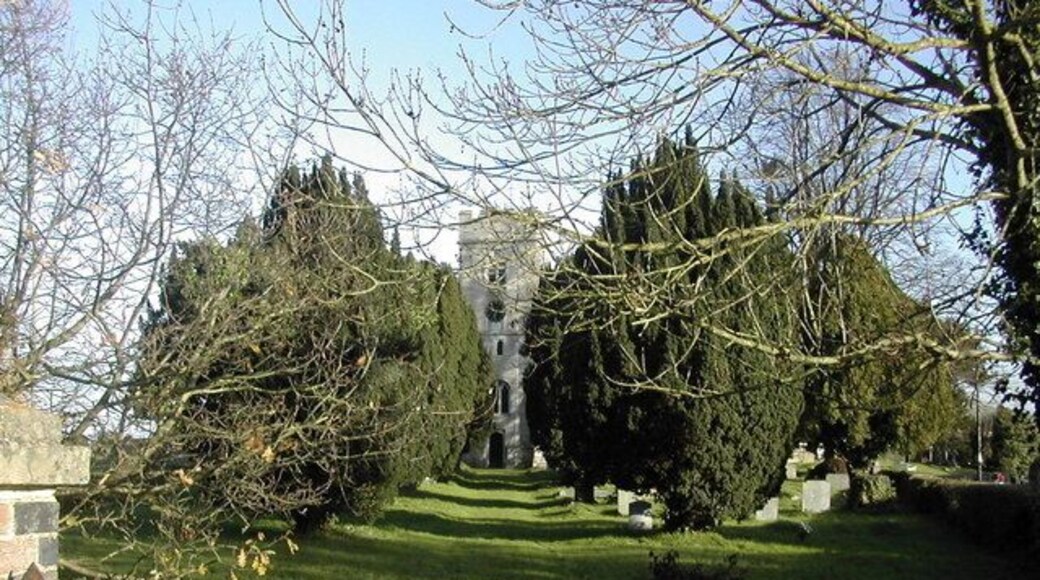 St James the Great parish churchyard, Saul, Gloucestershire, with the west tower of the church showing between the yews