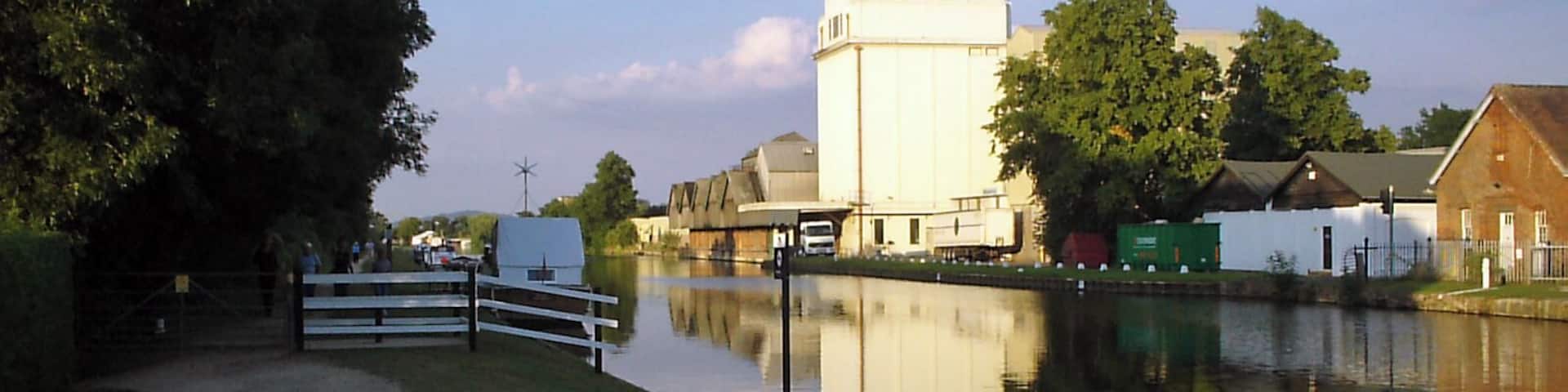 G&S Canal and former Cadbury's factory. Cadbury's opened a factory adjacent to the Gloucester & Sharpness canal near Fretherne Bridge in 1916. The factory produced chocolate crumb from ground cocoa beans, sugar, and milk from local farms before being transported to the Bournville factory in Birmingham by narrowboat. The silo in the centre of the picture was added later to provide additional storage. The factory is now occupied by several businesses including Shipton Mill.