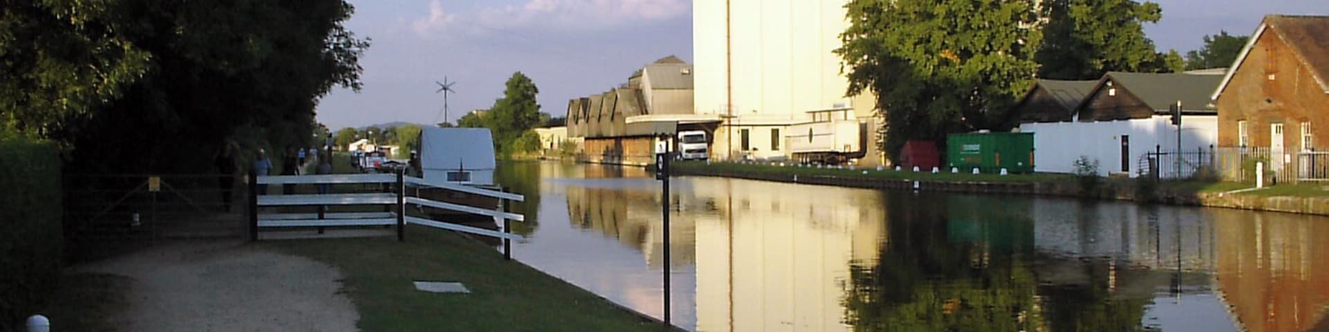 G&S Canal and former Cadbury's factory. Cadbury's opened a factory adjacent to the Gloucester & Sharpness canal near Fretherne Bridge in 1916. The factory produced chocolate crumb from ground cocoa beans, sugar, and milk from local farms before being transported to the Bournville factory in Birmingham by narrowboat. The silo in the centre of the picture was added later to provide additional storage. The factory is now occupied by several businesses including Shipton Mill.