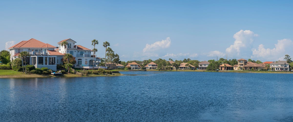A waterfront community with houses and a lake.