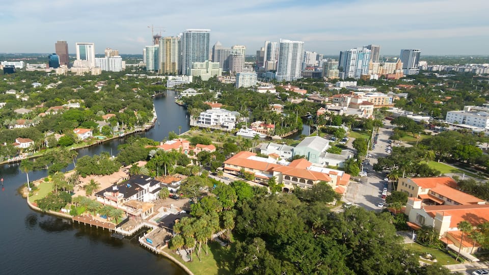 A cityscape with a river, residential areas, and high-rise buildings.