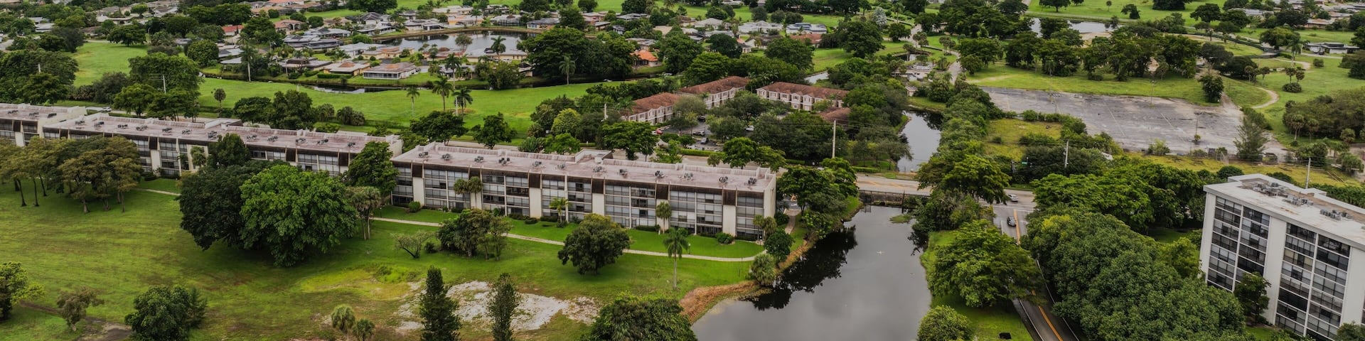 Aerial view of a suburban landscape with lush greenery under a cloudy sky. Lauderhill, Florida
