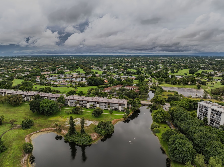 Aerial view of a suburban landscape with lush greenery under a cloudy sky. Lauderhill, Florida