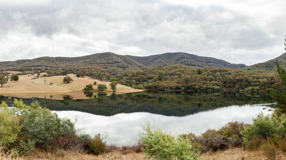 A lake surrounded by hills and trees.