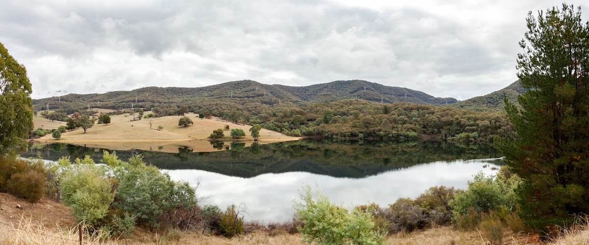 A lake surrounded by hills and trees.