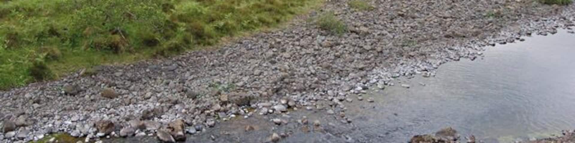 Enclosure south of the River Hinnisdal Looking across from the north of the river to a large area enclosed by a dry stone wall. Whether it was to keep animals in or out, I'm uncertain. It's no longer stockproof though.
