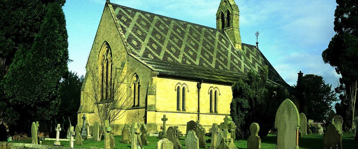 A church with a pointed roof and a bell tower.
