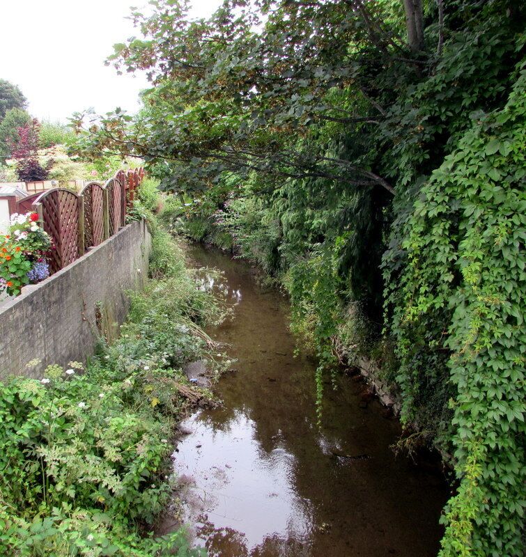 Cadoxton River, Dinas Powys. Flowing towards the camera on the north side of an A4055 Cardiff Road bridge. About 8km long, the streamlike Cadoxton River is one of the shortest rivers (so named) in Wales.