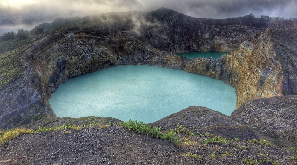 Tri-color crater lakes of Mount Kelimutu in Moni, Flores. Third crater's behind me. These two change color every once in a while and it's always unpredictable. In the past, they've turned pink, white, black, blood red, brown, and yellow.