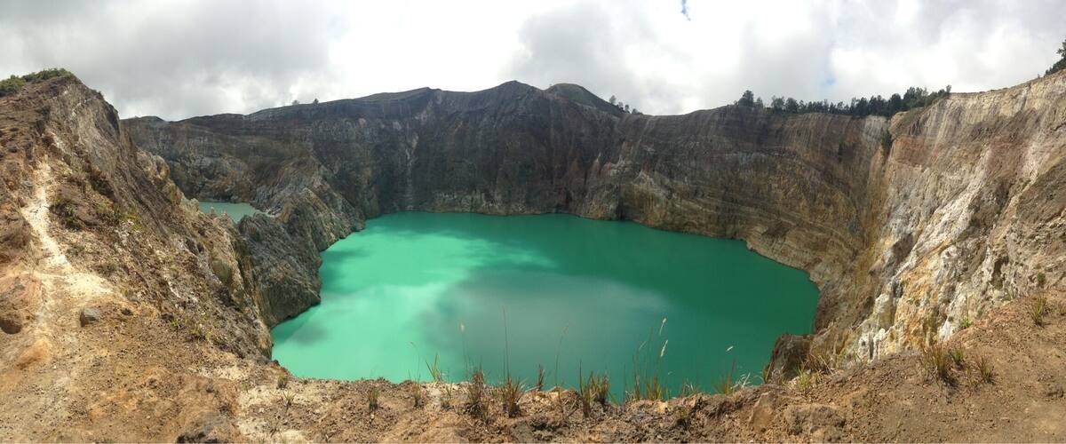 A large crater lake surrounded by steep, rocky cliffs.