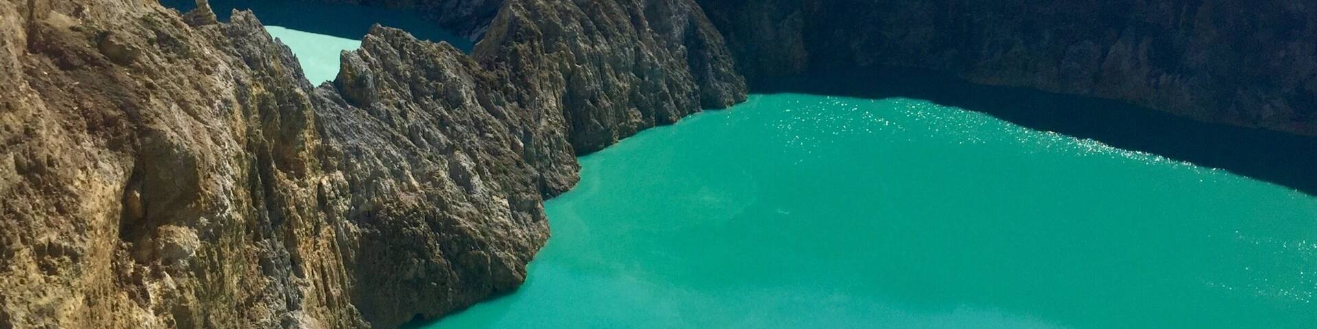 A deep blue lake surrounded by steep, rocky cliffs.