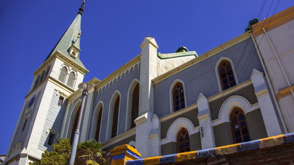 A historic building with a clock tower and arched windows.