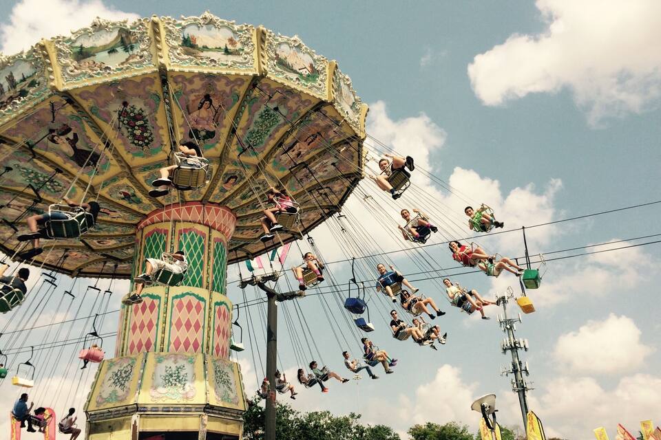A colorful carousel with riders enjoying the ride.