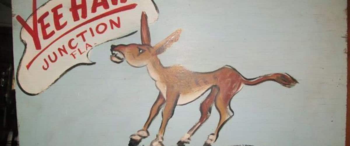 A vintage sign for Yee Haw Junction Desert Inn with a kangaroo illustration.