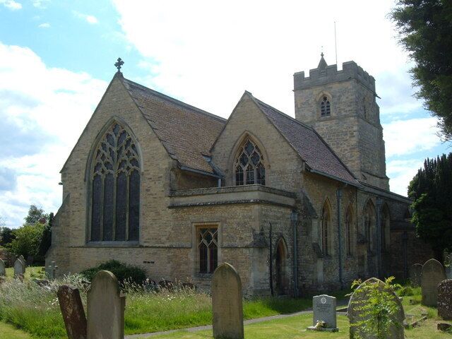 A church with a tall tower and large arched windows.