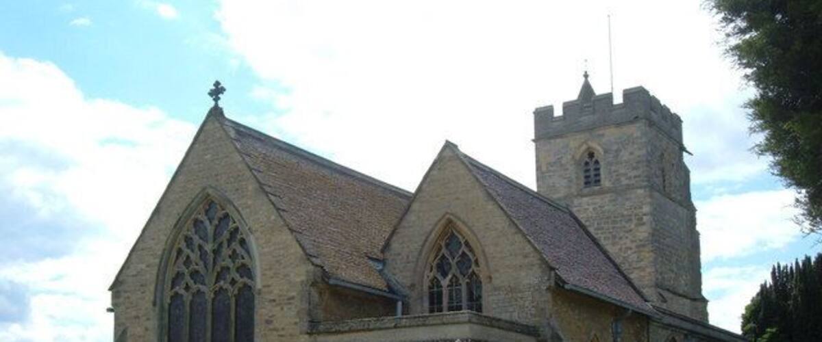 A church with a tall tower and large arched windows.