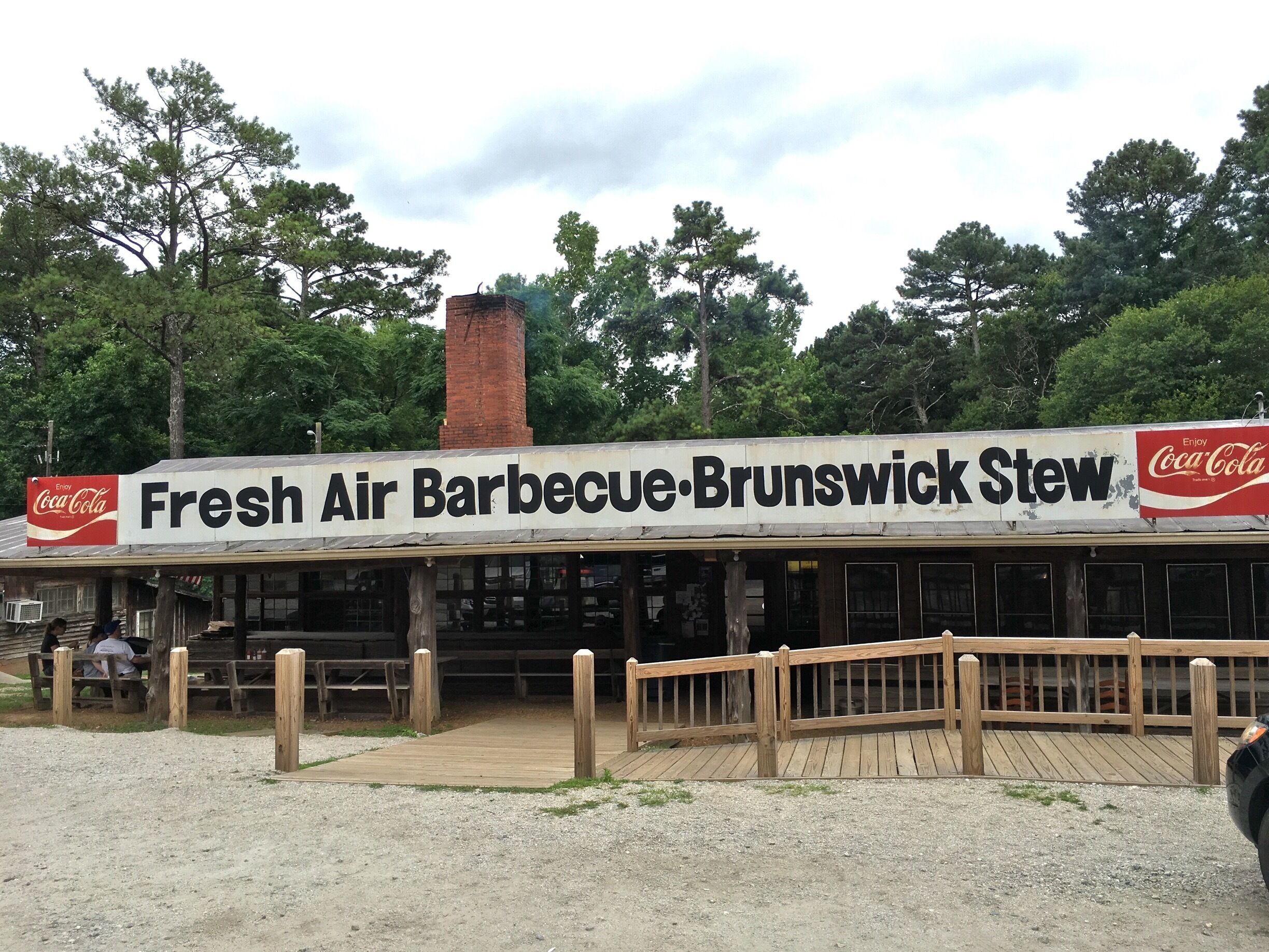The original Fresh Air Barbecue in Jackson, Georgia, is the oldest pit-cooked barbecue restaurant in Georgia still in its original location. Since its establishment in 1929 by Dr. Joel Watkins, Fresh Air Barbecue has served millions of barbecue sandwiches to the traveling public, from all over the United States.  The menu is very simple with on BBQ, Brunswick Stew and Cole Slaw.  Fresh Air Barbecue is known for having one of the shortest menus of any restaurant around. Cole slaw is one of the few major items that have been added to it in the last 80 years.  