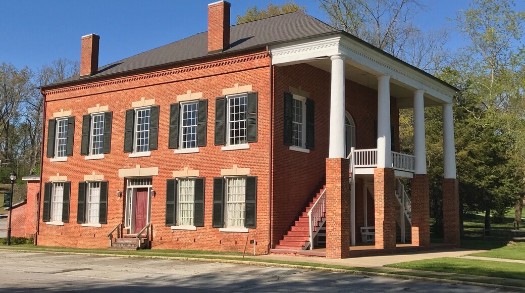 The Old Banks County Courthouse is in Homer, Georgia. Construction started in 1860 but was interrupted because of the Civil War. Construction was paid for with $6,600 in Confederate money. Construction was finished in 1875. (The Georgia Courthouse Manual dates it as completed in 1863.) The building is a two-story brick courthouse with a stone foundation in the Greek Revival style. It is similar to many courthouses in Virginia, which is a result of the builders being from Virginia. It has Tuscan columns that are on top of one-story brick piers. The interior originally had a cross plan. The courtroom and judge's chambers are on the second floor, which are accessed by outside double stairways.