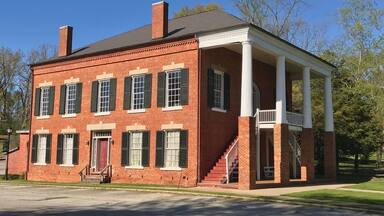 The Old Banks County Courthouse is in Homer, Georgia. Construction started in 1860 but was interrupted because of the Civil War. Construction was paid for with $6,600 in Confederate money. Construction was finished in 1875. (The Georgia Courthouse Manual dates it as completed in 1863.) The building is a two-story brick courthouse with a stone foundation in the Greek Revival style. It is similar to many courthouses in Virginia, which is a result of the builders being from Virginia. It has Tuscan columns that are on top of one-story brick piers. The interior originally had a cross plan. The courtroom and judge's chambers are on the second floor, which are accessed by outside double stairways.