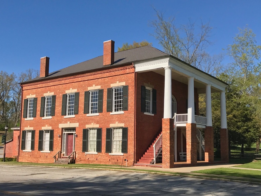 The Old Banks County Courthouse is in Homer, Georgia. Construction started in 1860 but was interrupted because of the Civil War. Construction was paid for with $6,600 in Confederate money. Construction was finished in 1875. (The Georgia Courthouse Manual dates it as completed in 1863.) The building is a two-story brick courthouse with a stone foundation in the Greek Revival style. It is similar to many courthouses in Virginia, which is a result of the builders being from Virginia. It has Tuscan columns that are on top of one-story brick piers. The interior originally had a cross plan. The courtroom and judge's chambers are on the second floor, which are accessed by outside double stairways.