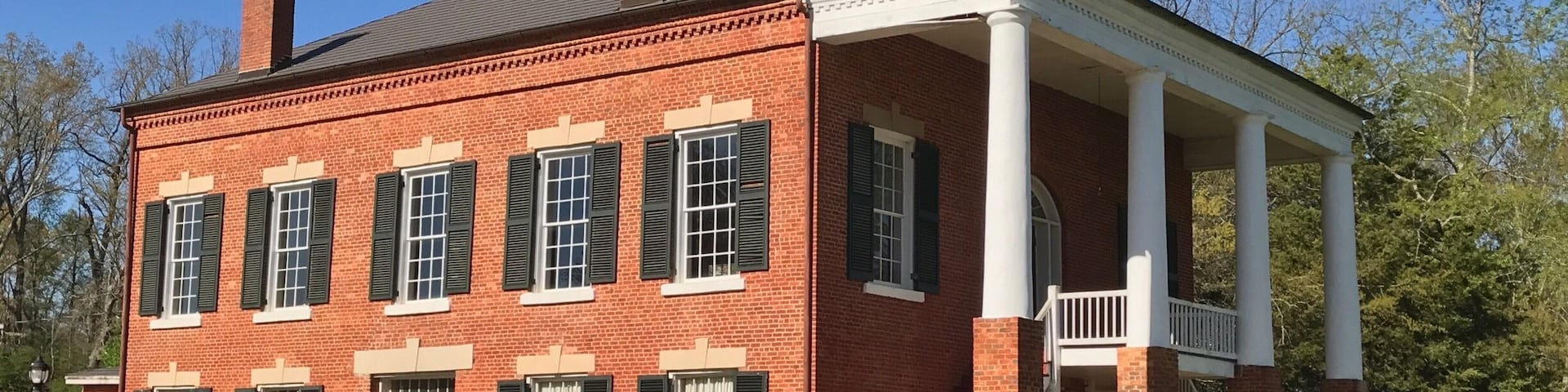 The Old Banks County Courthouse is in Homer, Georgia. Construction started in 1860 but was interrupted because of the Civil War. Construction was paid for with $6,600 in Confederate money. Construction was finished in 1875. (The Georgia Courthouse Manual dates it as completed in 1863.) The building is a two-story brick courthouse with a stone foundation in the Greek Revival style. It is similar to many courthouses in Virginia, which is a result of the builders being from Virginia. It has Tuscan columns that are on top of one-story brick piers. The interior originally had a cross plan. The courtroom and judge's chambers are on the second floor, which are accessed by outside double stairways.