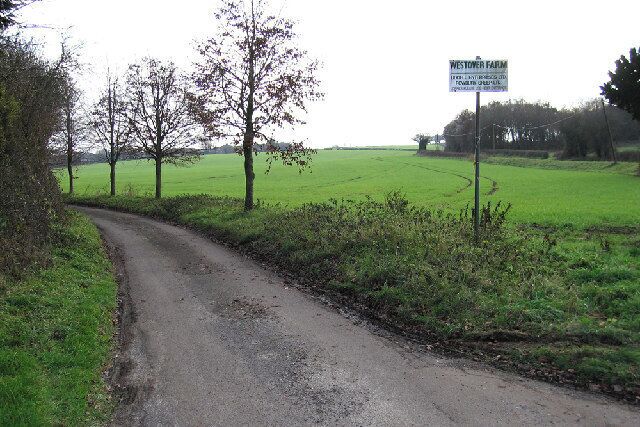 A rural road with a sign for Westtor Farm.