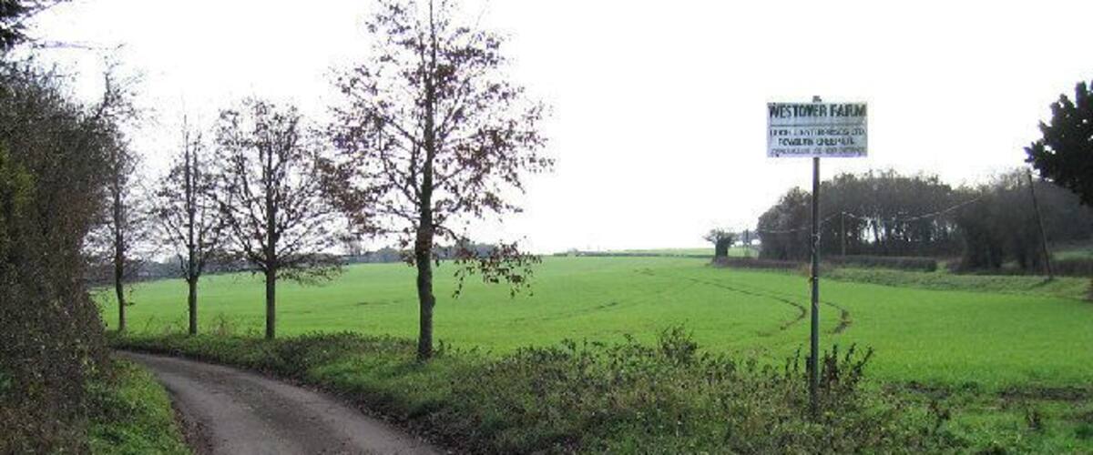 A rural road with a sign for Westtor Farm.