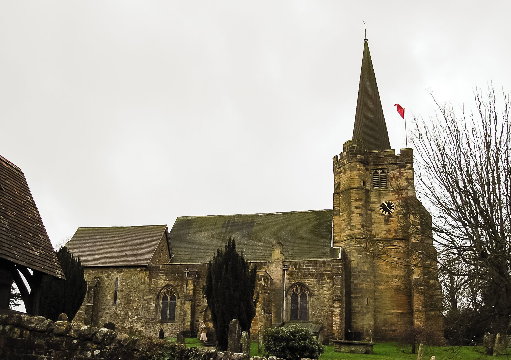 A historic church with a tall spire and a clock tower.
