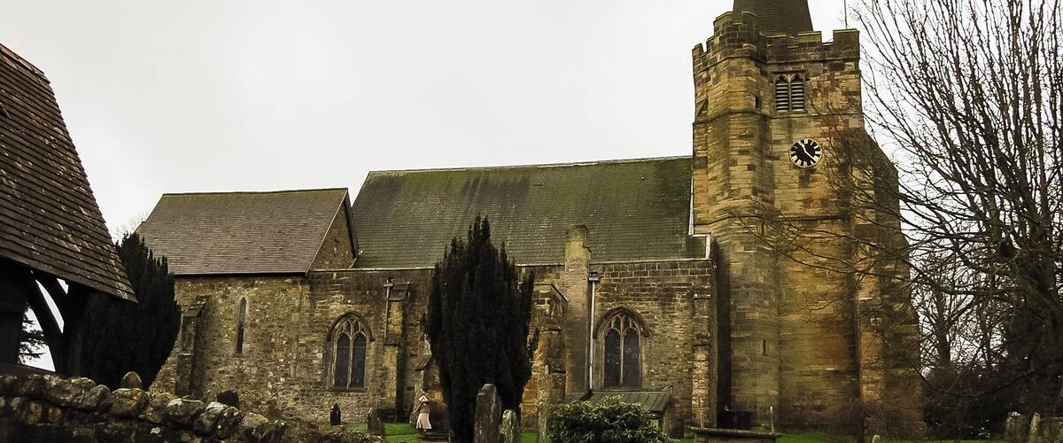 A historic church with a tall spire and a clock tower.
