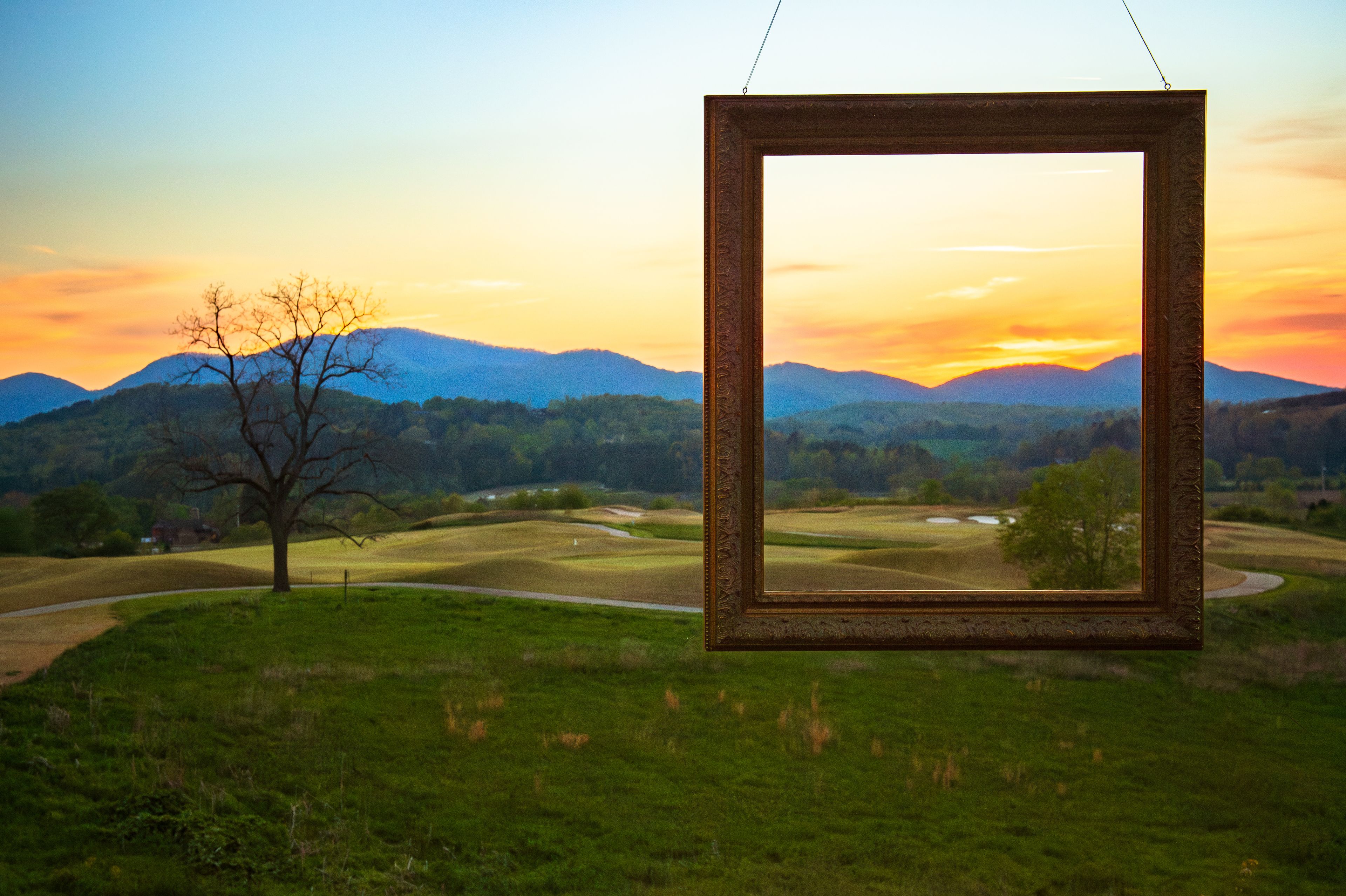 A frame in front of the scenery of a golf course in the North Georgia Mountains